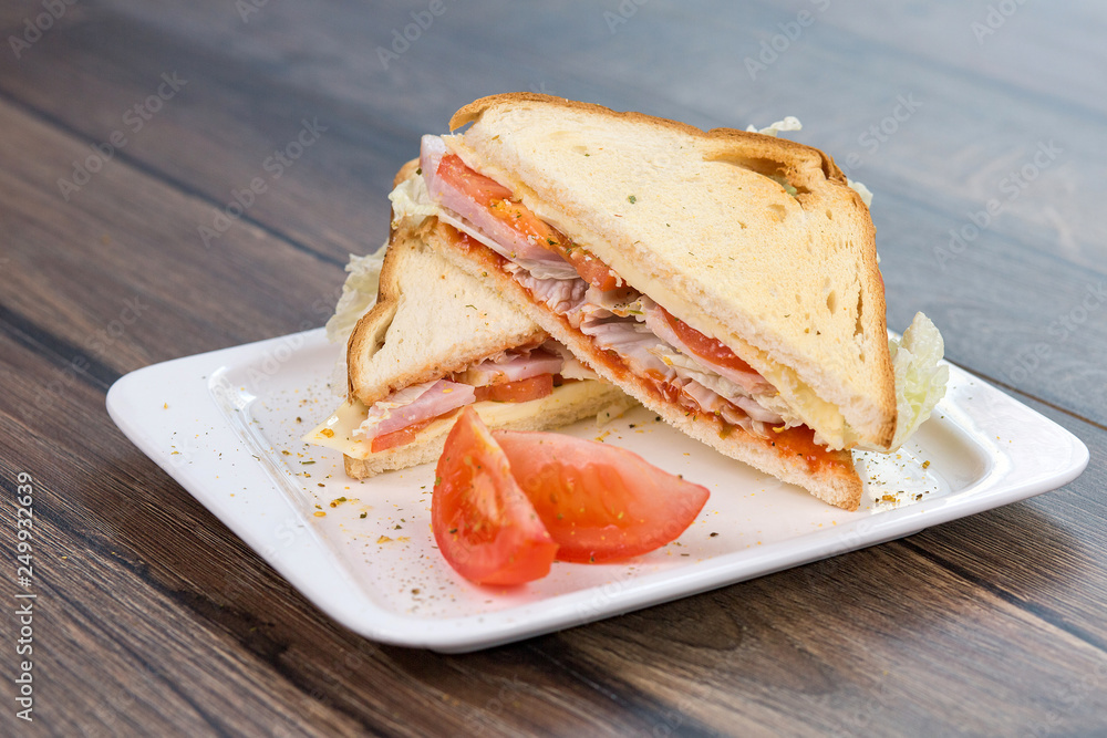 Sandwich with tomatoes and bacon on plate. Breakfast, food phto concept Sandwich with tomatoes and bacon on plate. Breakfast, food phto concept