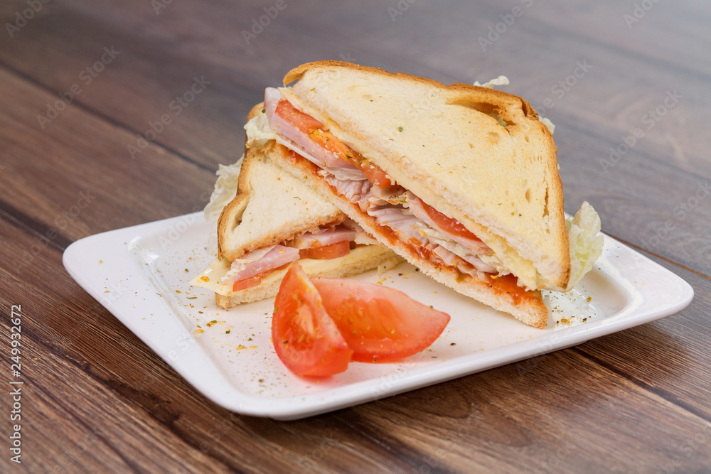 Sandwich with tomatoes and bacon on plate. Breakfast, food phto concept Sandwich with tomatoes and bacon on plate. Breakfast, food phto concept