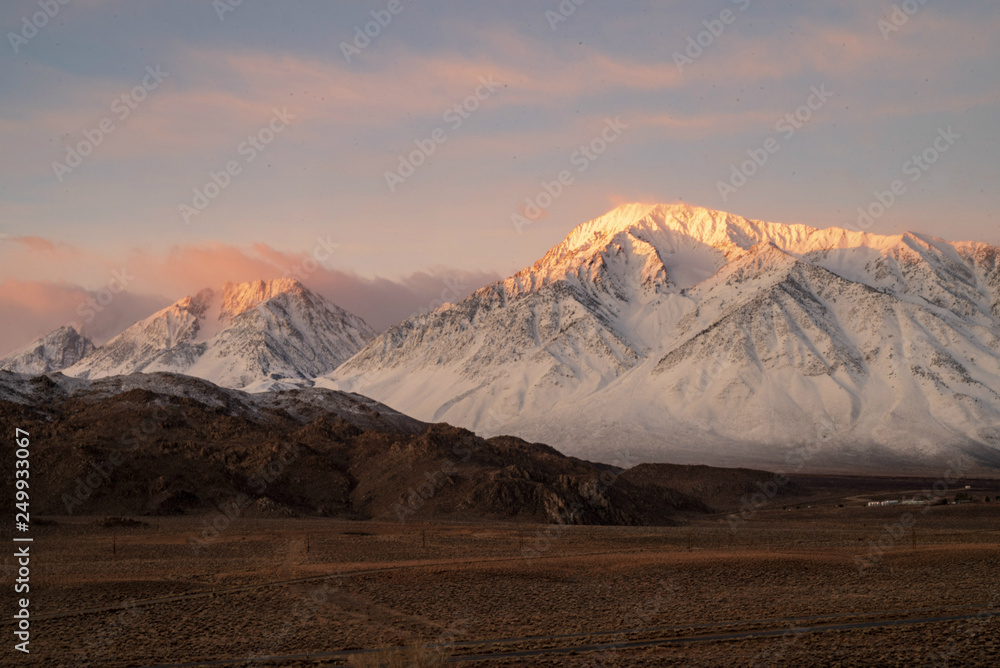 sunrise colorful clouds and snowy peak Sierra Nevada mountains, hill, desert valley, California, USA