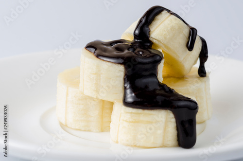 Sliced ​​bananas in chocolate icing on a light background