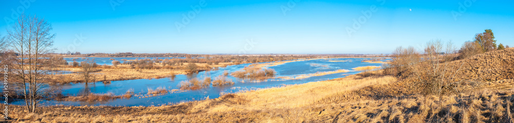 scenic landscape with hills covered with yellow grass and blue river under a clear sunny sky, panorama scenic landscape with hills covered with yellow grass and blue river under a clear sunny sky, panorama