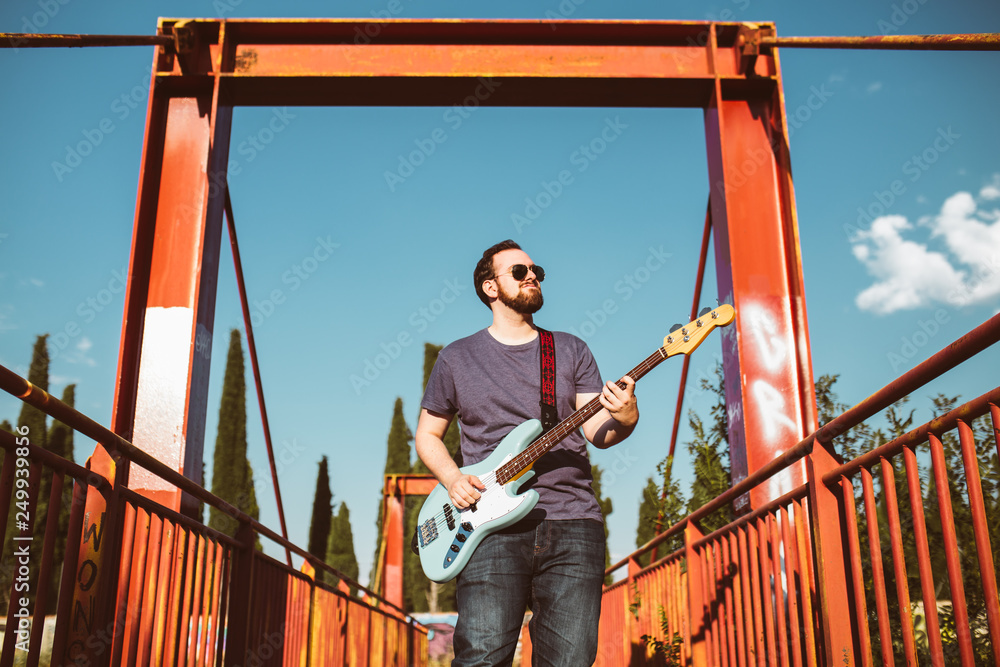 outdoor photo session with a bass player and his instruments