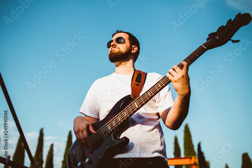 outdoor photo session with a bass player and his instruments