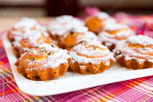 Delicious cakes on desk with sugar and raisins. Food photo for menu