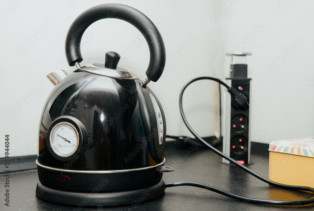 Black electric kettle. Kettle for heating water. The concept of using water to wash dishes, for pouring water. Problems with water. Black electric kettle. Kettle for heating water. The concept of using water to wash dishes, for pouring water. Problems with water.
