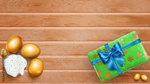 Realistic golden Easter eggs, tasty cake and beautiful gift box with bow on wooden planks