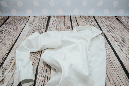 Fotografija A white business shirt is messy on a wooden floor