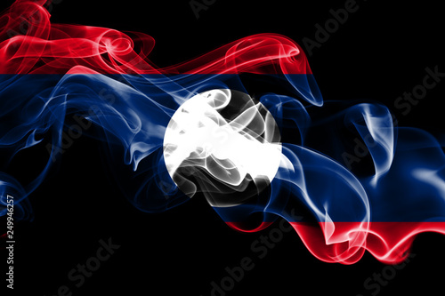 National flag of Laos made from colored smoke isolated on black background. Abstract silky wave background.