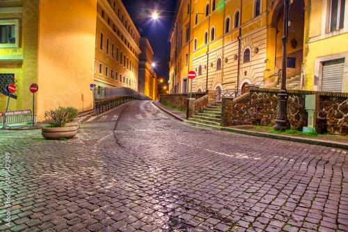 night street in Rome and cobblestone pedestrian road