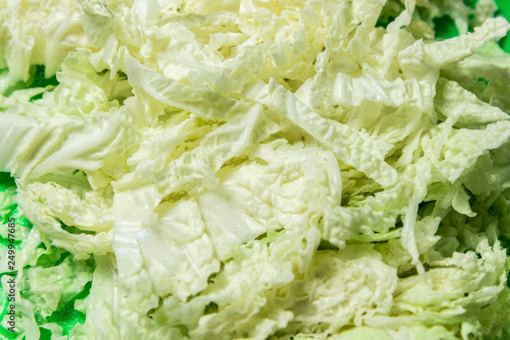 Sliced Chinese cabbage on a green board for the whole frame Sliced Chinese cabbage on a green board for the whole frame