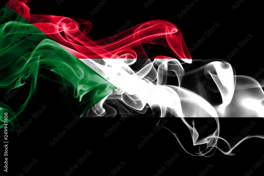 National flag of Sudan made from colored smoke isolated on black background. Abstract silky wave background. National flag of Sudan made from colored smoke isolated on black background. Abstract silky wave background.