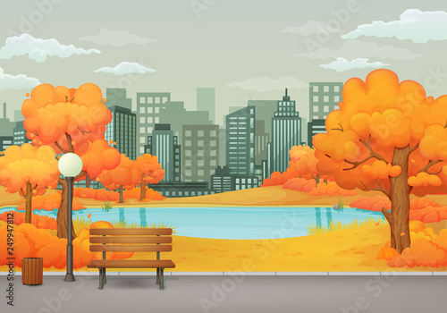 Autumn day park scene. Bench with trash can and street lamp on an asphalt park trail with yellow trees and bushes. Lake, cityscape with skyscrapers and gray sky with clouds in the background.