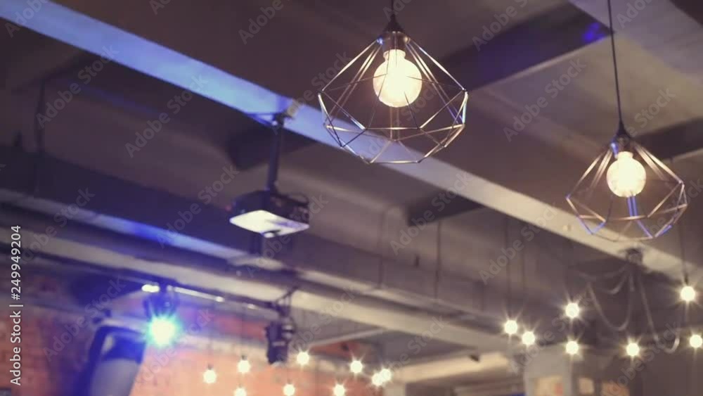 Unusual lamps in the room hang on the ceiling. Lamp art. Loft lighting. Unusual lamps in the room hang on the ceiling. Lamp art. Loft lighting.