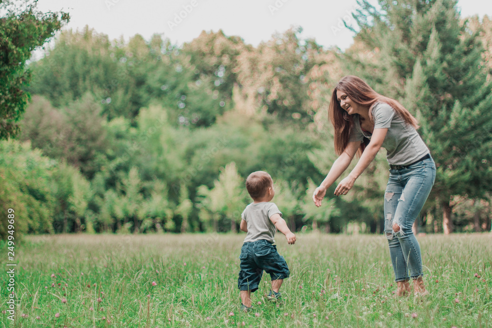 Mother play with son in the park.