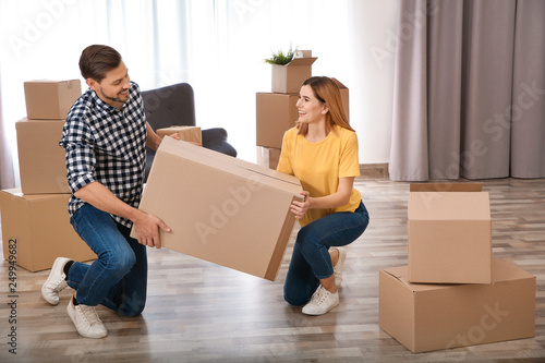 Couple with moving box in their new house