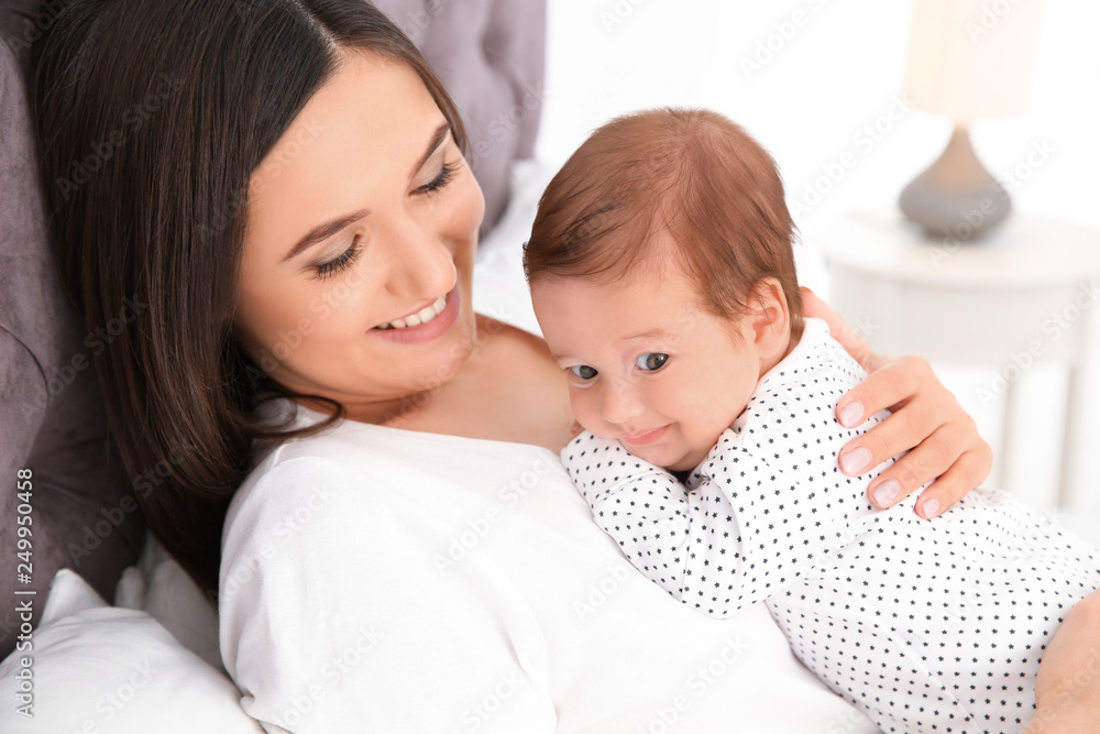 Happy woman with her cute baby on bed Happy woman with her cute baby on bed
