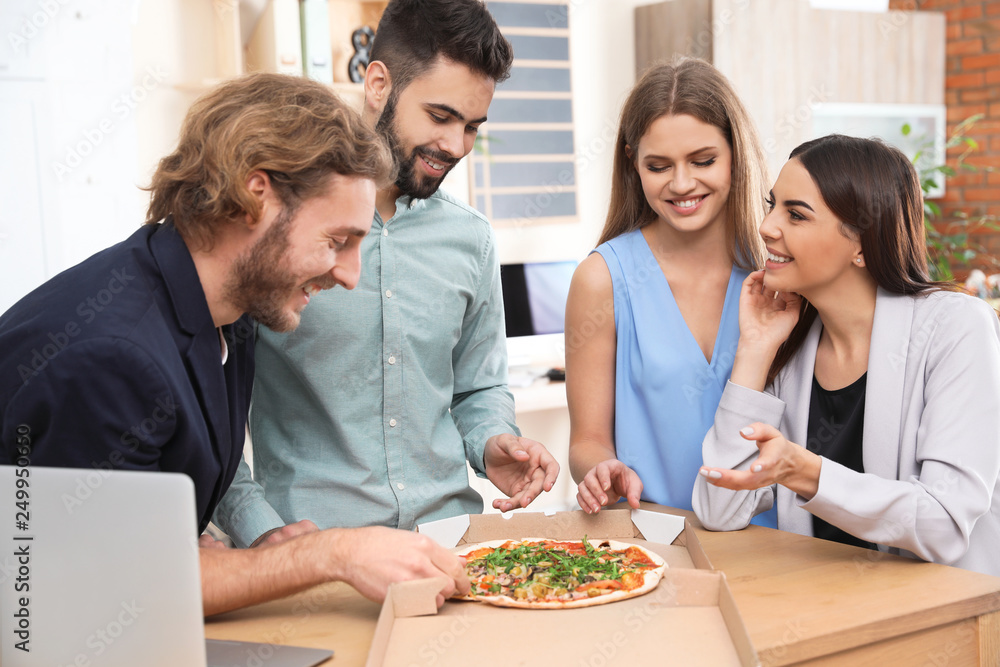 Office employees having pizza for lunch at workplace. Food delivery