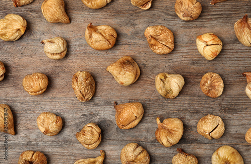 Flat lay composition with figs on wooden background. Dried fruit as healthy food