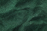Spirulina algae powder as background, top view
