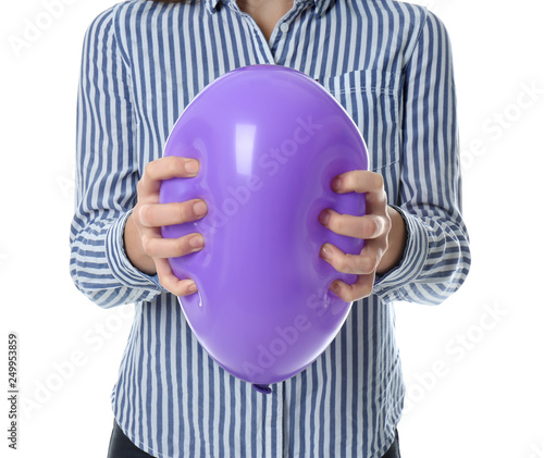 Woman squeezing purple balloon on white background, closeup