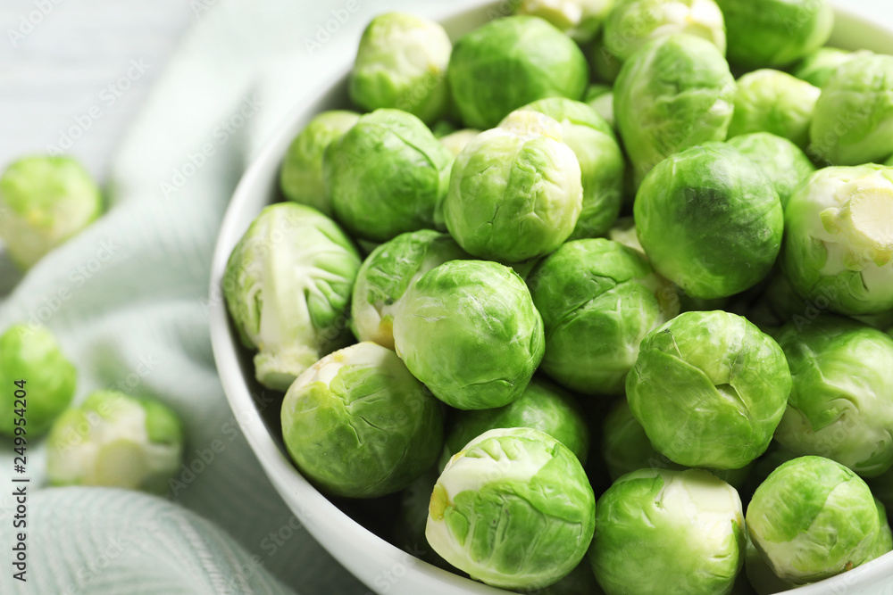 Bowl of fresh Brussels sprouts on fabric, closeup Bowl of fresh Brussels sprouts on fabric, closeup
