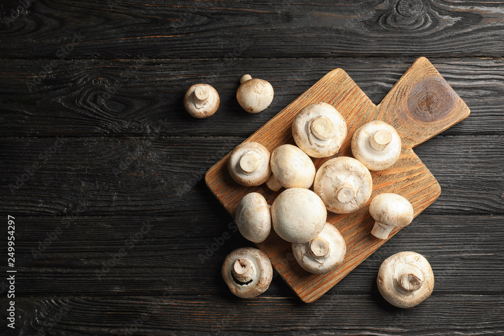 Flat lay composition with fresh champignon mushrooms on wooden table. Space for text Flat lay composition with fresh champignon mushrooms on wooden table. Space for text
