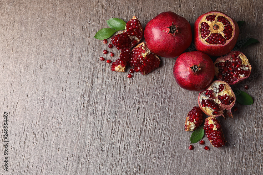 Composition with ripe pomegranates and space for text on color background, top view Composition with ripe pomegranates and space for text on color background, top view