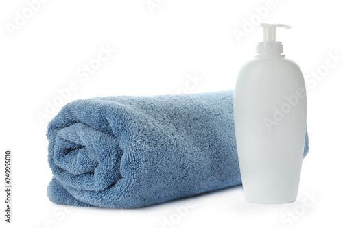 Rolled towel and shampoo isolated on white