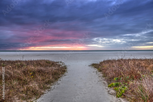 White sand path leading through the beach grass at Tigertail Beach at sunset photo