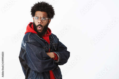 Wow that impressive. Amazed and surprised african american charismatic man with beard, pierced nose and afro hairstyle turning at camera intrigued and astonished, folding lips in amazement