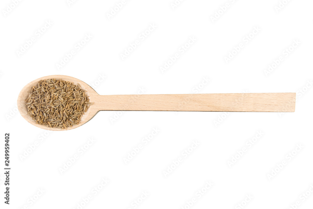 cumin in wooden spoon isolated on white background. Closeup. cumin in wooden spoon isolated on white background. Closeup.