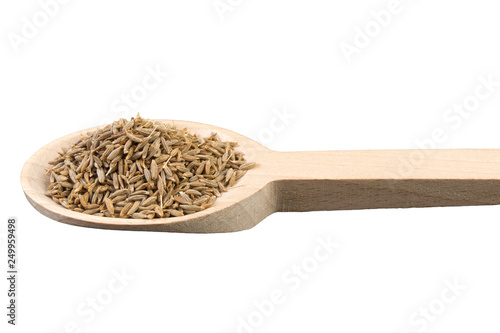 cumin in wooden spoon isolated on white background. Closeup.
