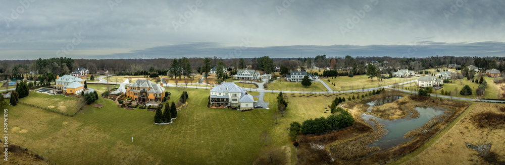 Aerial panorama of American luxury real estate neighborhood in Maryland with single family houses, mansions, high quality buildings with lot of land Aerial panorama of American luxury real estate neighborhood in Maryland with single family houses, mansions, high quality buildings with lot of land