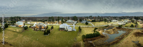 Aerial panorama of American luxury real estate neighborhood in Maryland with single family houses, mansions, high quality buildings with lot of land