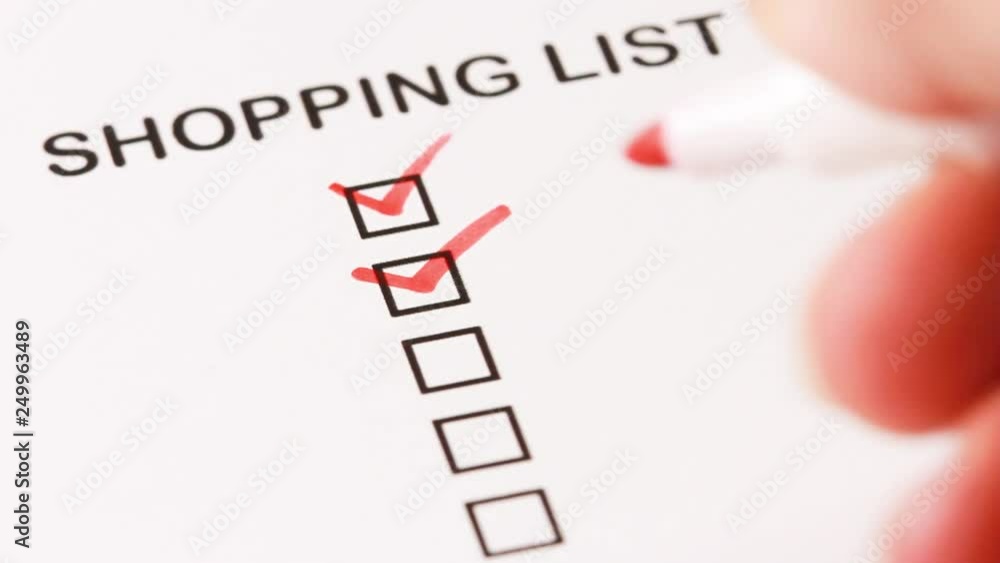 Person check all the boxes on checkbox shopping list . Person check all the boxes on checkbox shopping list .