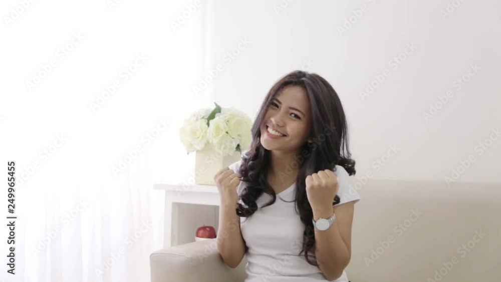 happy excited asian young woman raised her arm happy excited asian young woman raised her arm