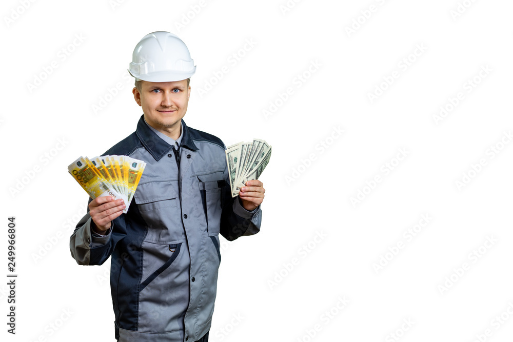 Worker in overalls shows money in his hands. On the construction or repair can earn dollars and euros. isolated Worker in overalls shows money in his hands. On the construction or repair can earn dollars and euros. isolated