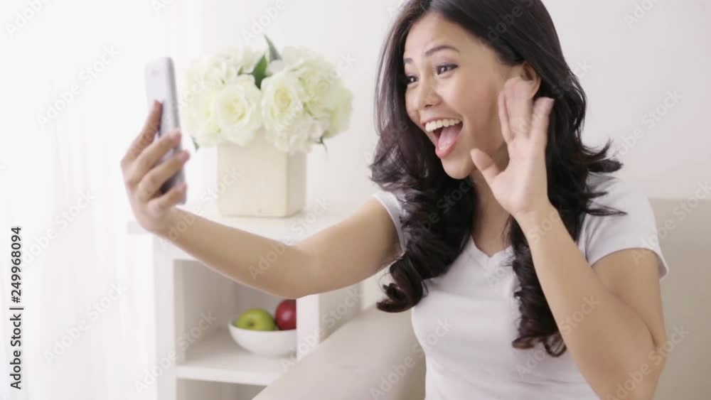 happy young asian woman using smart phone and smile while doing some video call happy young asian woman using smart phone and smile while doing some video call