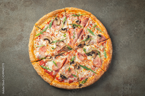 Delicious hot pizza with ham and champignons.