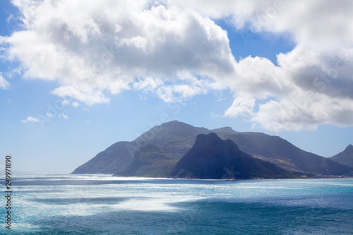 Seascape turquoise ocean water  blue sky  white clouds panorama  bright sun  azure sea shore  summer vacation concept  beautiful nature mountains view landscape  Cape Town  South Africa coast travel