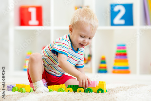 Kid boy playing toys at hom...