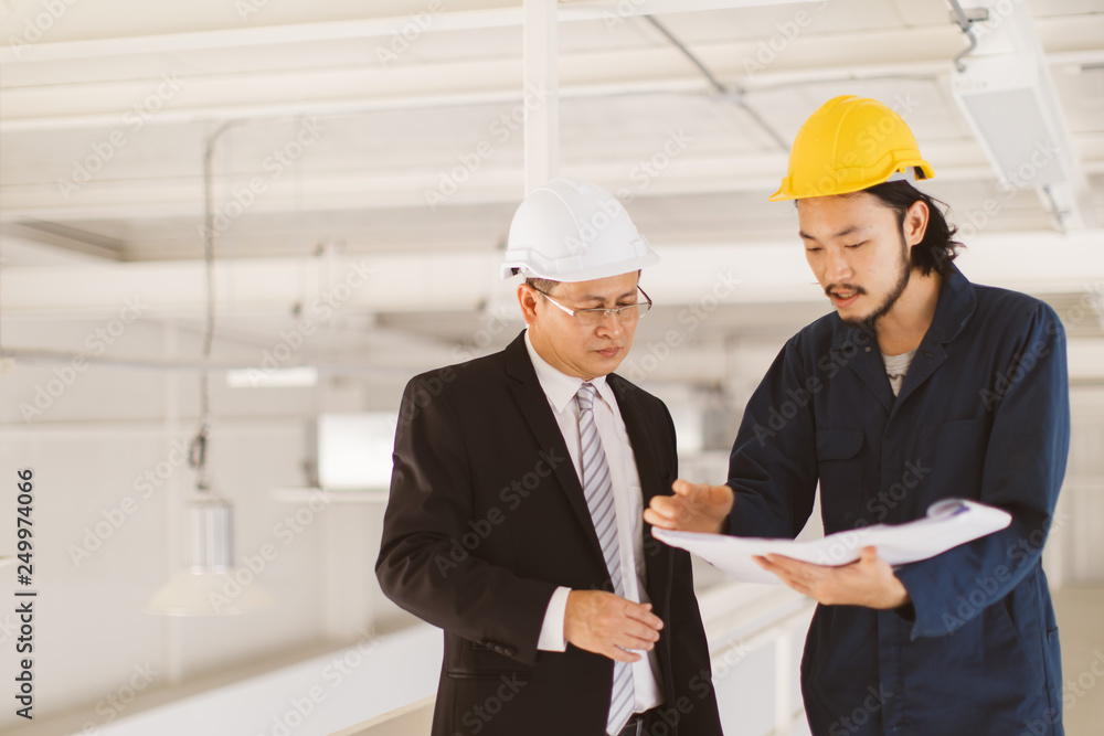 Asian engineers look at blueprint.. Asian engineers look at blueprint..