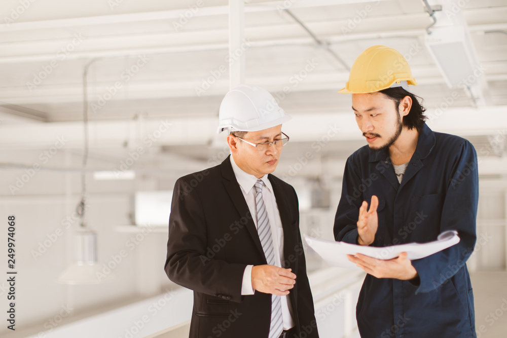 Asian engineers look at blueprint.. Asian engineers look at blueprint..