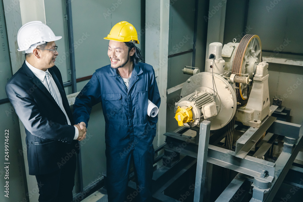Asian engineers standing and smile to camera.. Asian engineers standing and smile to camera..