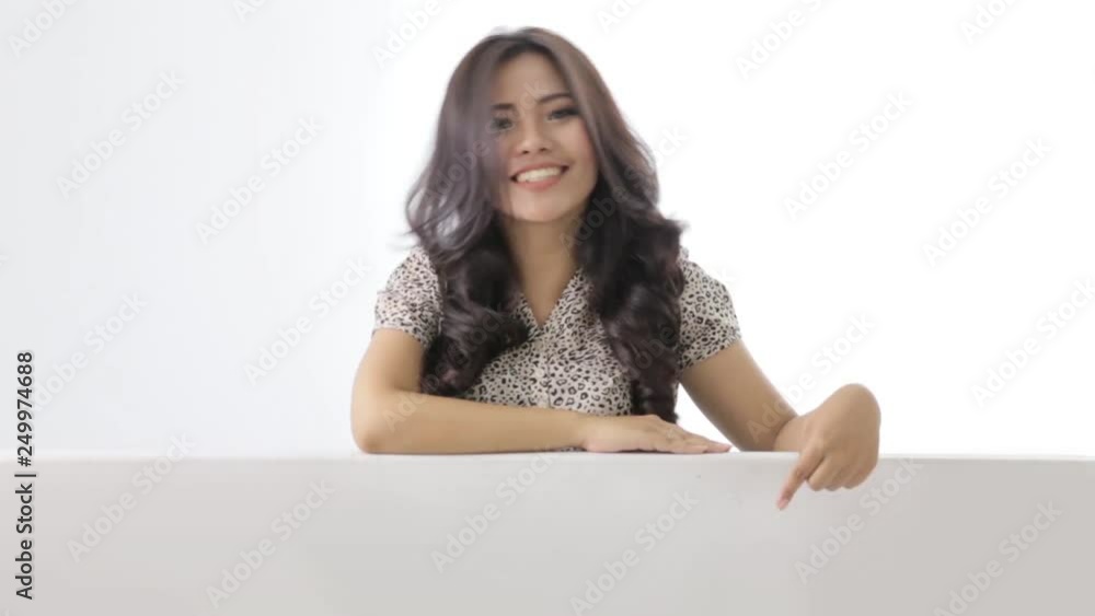 happy young asian businesswoman pointing to white board below her happy young asian businesswoman pointing to white board below her
