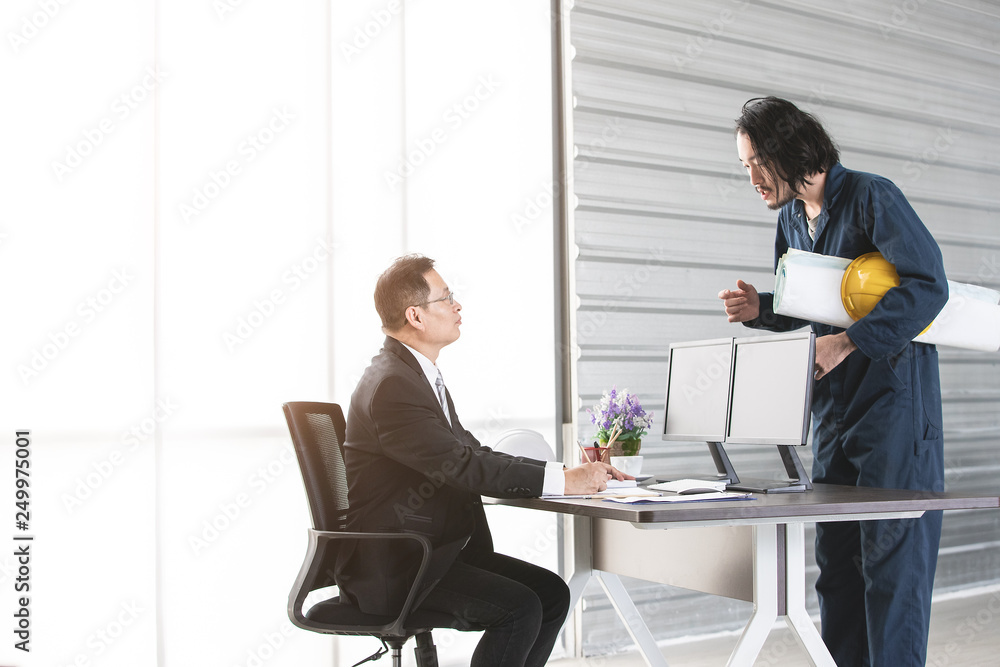 Young engineer present work to executive engineer.. Young engineer present work to executive engineer..