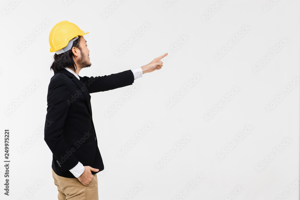Portrait of Asian engineer pointing at wall..