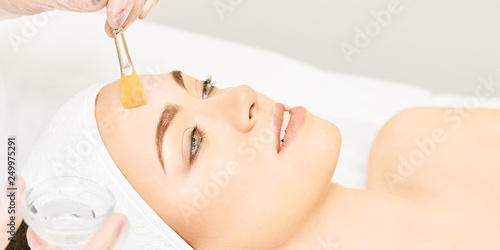 Facial brush peel retinol treatment. Beauty woman peeling procedure. Cosmetology young girl therapy.Hyaluronic acid