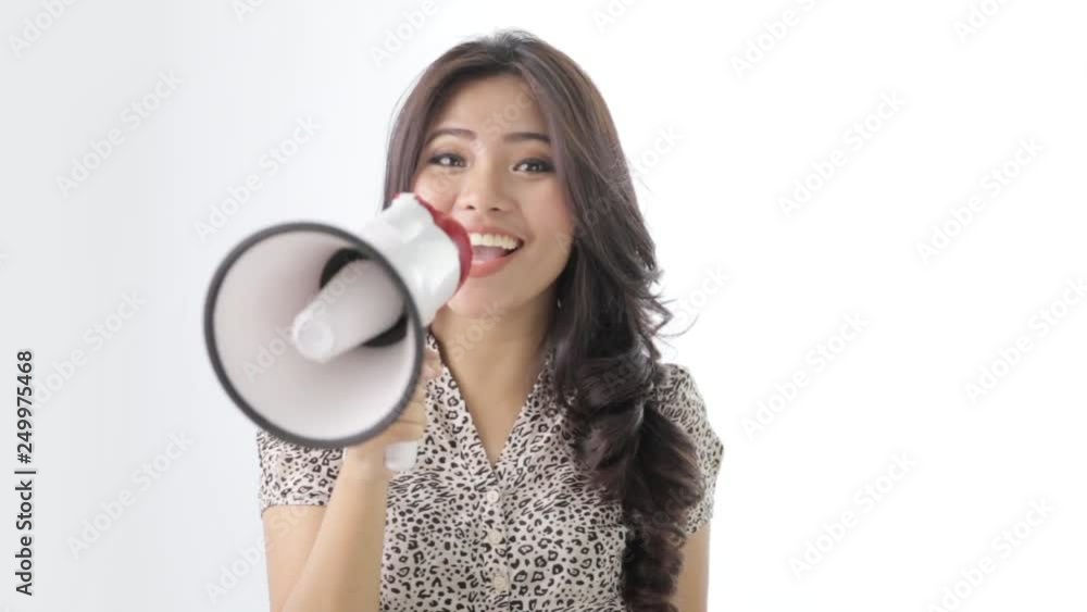 young asian woman shouting using megaphone on white background young asian woman shouting using megaphone on white background