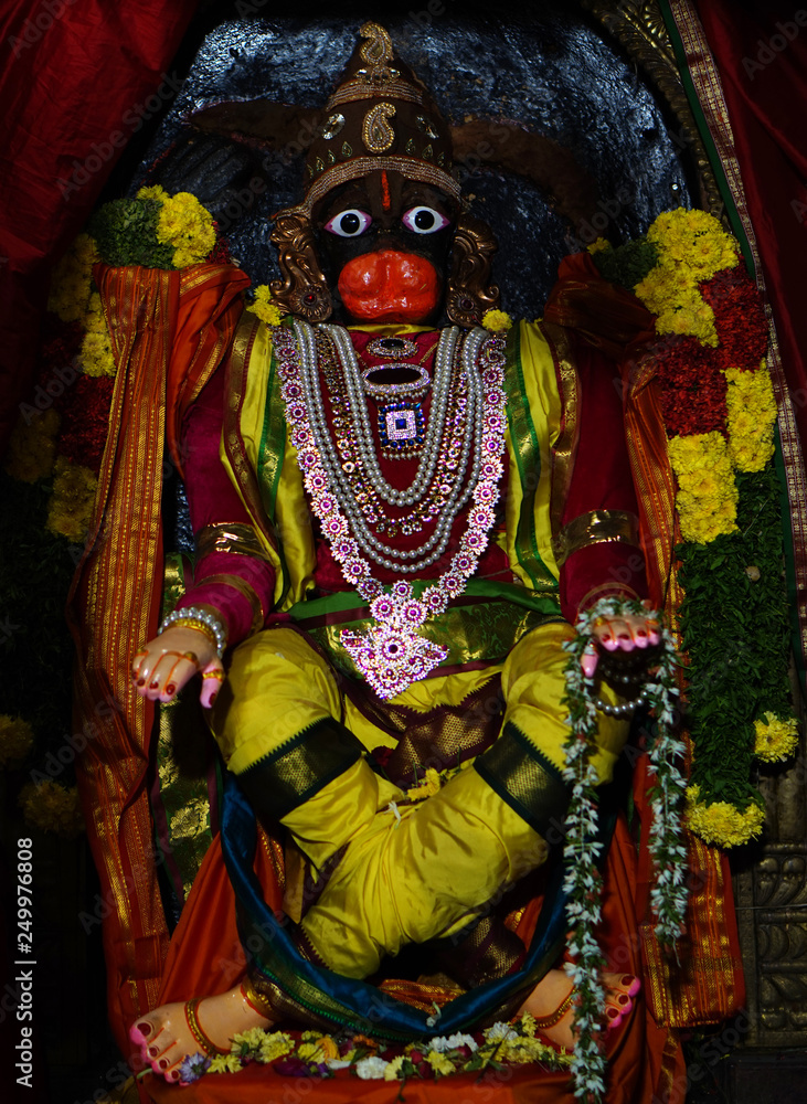 Closeup view of Hindu god Hanuman stone carved statue,decoration during festival in a temple 